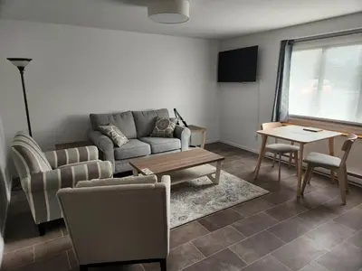 a living room with a couch and a table at D&G Suite Retreat in Sidney