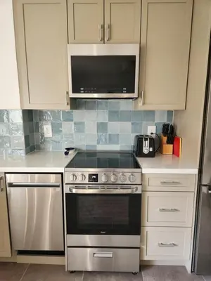 a kitchen with a stove and a microwave at D&G Suite Retreat in Sidney