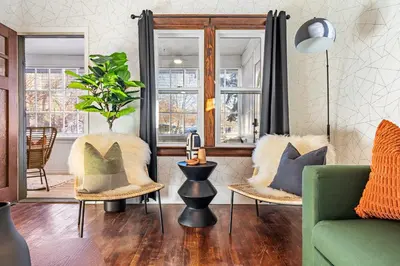 a living room with a green couch and chairs at The Sandlot Family in Drumheller
