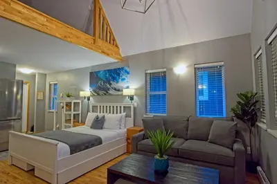 a living room with a bed and a couch at Tide and Trail- Cabin in Ucluelet in Ucluelet