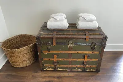 two old trunks with towels on top and a basket at Raven Lady #201- Ucluelet Sleeps 6 Pet Friendly in Ucluelet