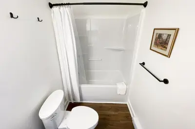 a white bathroom with a toilet and a shower at Raven Lady #201- Ucluelet Sleeps 6 Pet Friendly in Ucluelet