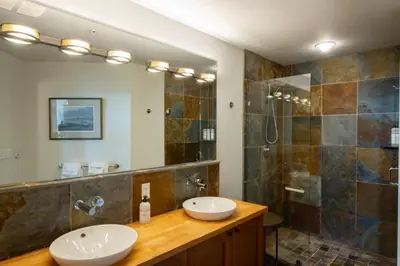 a bathroom with two sinks and a shower at Big Beach Escape - Ucluelet - Sleeps 6 - Pet Friendly in Ucluelet