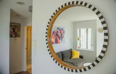 a mirror in a living room with a couch at Luxury Ocean view Apartment- Heart of Yaletown Downtown Vancouver in Vancouver