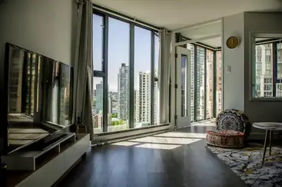 a large room with large windows in a building at Luxury Ocean view Apartment- Heart of Yaletown Downtown Vancouver in Vancouver