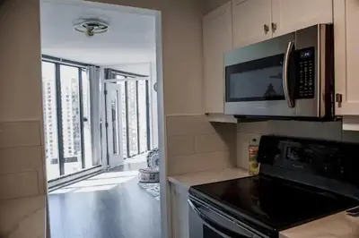 a kitchen with a microwave and a stove top oven at Luxury Ocean view Apartment- Heart of Yaletown Downtown Vancouver in Vancouver