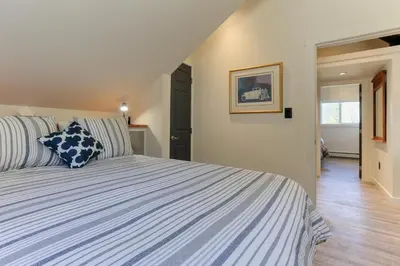 a bedroom with a bed with blue and white stripes at 