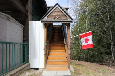 a stairway to a house with a canadian flag at 