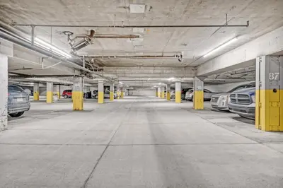 an empty parking garage with cars parked in it at Stylish Suite at Stampede w Free Parking and AC in Calgary