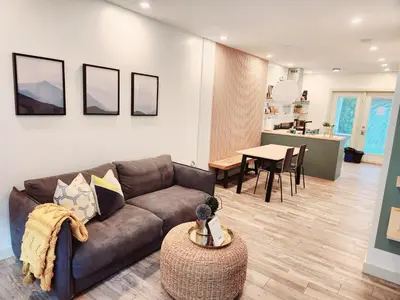 a living room with a couch and a table at The OVERLOOK Stay-Mountain View-Free Parking in Canmore