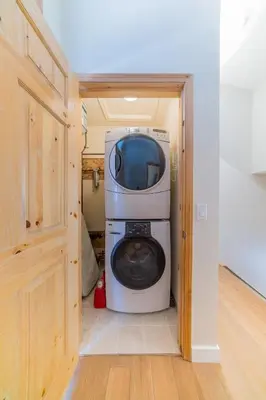 a washer and dryer in a small room at The OVERLOOK Stay-Mountain View-Free Parking in Canmore