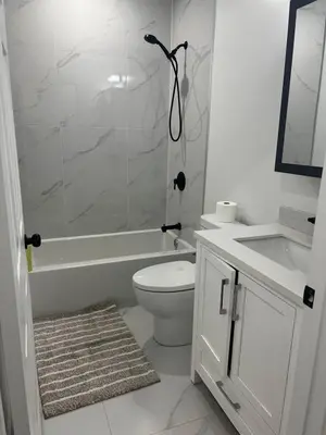 a bathroom with a shower and a toilet and a sink at Basement in Keswick Edmonton in Edmonton