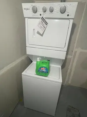 a green detergent sitting on top of a white stove at Modern suite in basement Upland in Edmonton