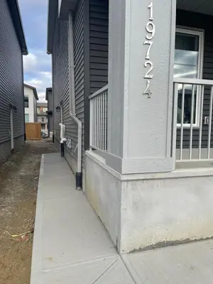 a building with a sign on the side of it at Modern suite in basement Upland in Edmonton