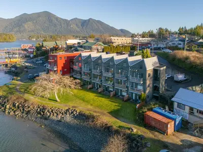 an aerial view of a building next to the water at Tofino Eco Waterfront Condo in Tofino