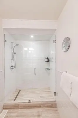 a bathroom with a shower with a glass door at Premium 4-Bedroom Chalet in Whistler