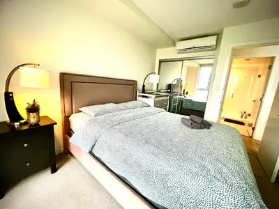 a bedroom with a bed and a dresser and a mirror at Fantastic and comfortable 2B2B center of Richmond in Richmond
