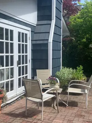 two chairs and a table on a patio at West Vancouver 3 bedroom Spacious Very Well Maintained Close to Ocean Mts Hikes Golf Shopping City Whistler in West Vancouver