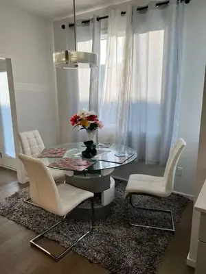 a dining room with a glass table and two chairs at Bedroom in Southwest A in Edmonton