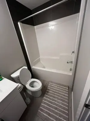a small bathroom with a toilet and a shower at Brand New Bedroom in Keswick A in Edmonton