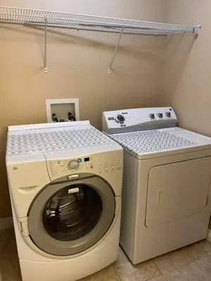 a washer and dryer in a laundry room at Ogden 3-Bed Home in Calgary