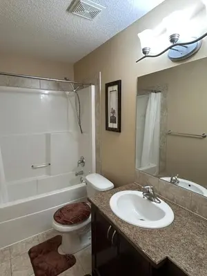 a bathroom with a sink and a toilet and a tub at Ogden 3-Bed Home in Calgary