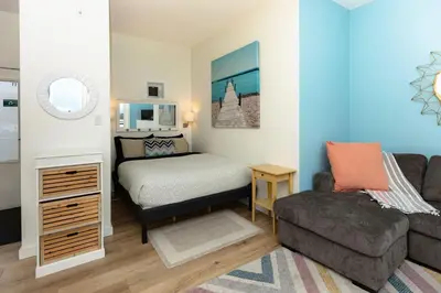 a living room with a bed and a couch and a chair at Tofino Waterfront Condo in Tofino