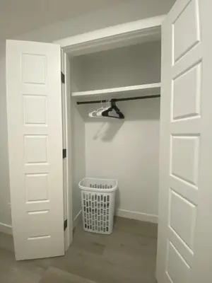 a room with a door and a trash can at Carrington Cozy Suite, Calgary in Calgary