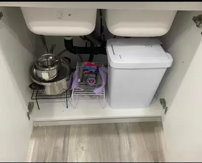 a bathroom with a toilet and a shelf under a sink at Carrington Cozy Suite, Calgary in Calgary