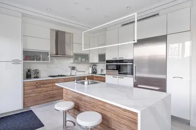 a kitchen with white cabinets and a counter with stools at Centrally Located Luxury Home with Views and Cinema in Vancouver
