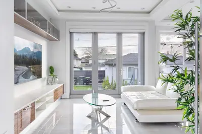 a living room with a white couch and a glass table at Centrally Located Luxury Home with Views and Cinema in Vancouver