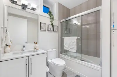 a bathroom with a toilet and a shower and a sink at Centrally Located Luxury Home with Views and Cinema in Vancouver