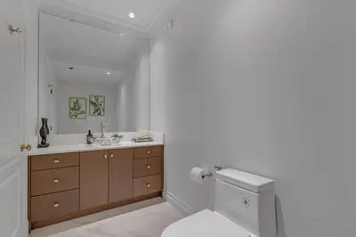 a white bathroom with a sink and a toilet at Beautiful 5 bedroom West Vancouver Mansion in West Vancouver