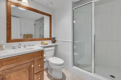 a bathroom with a toilet and a glass shower at Beautiful 5 bedroom West Vancouver Mansion in West Vancouver