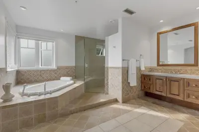 a bathroom with a tub and a shower and a sink at Beautiful 5 bedroom West Vancouver Mansion in West Vancouver
