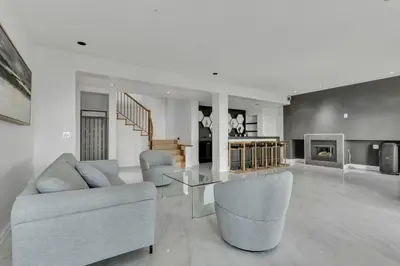a living room with a couch and a table and chairs at Beautiful 5 bedroom West Vancouver Mansion in West Vancouver