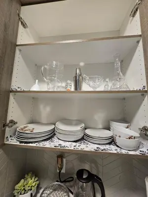 a shelf with plates and other dishes in a kitchen at Cornerstone 4-Bed Home in Calgary