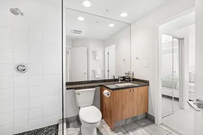 a bathroom with a toilet and a sink at 2BR plus Loft and Sofabed in Tyndall Stone Lodge, Epic Village Location, Mountain Views, Pool and Hot Tub in Whistler