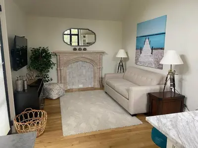 a living room with a couch and a fireplace at Chateau Calcaire Carriage House in Kelowna