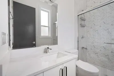 a white bathroom with a sink and a toilet at Stylish Retreat in Agassiz with Scenic Views in Agassiz