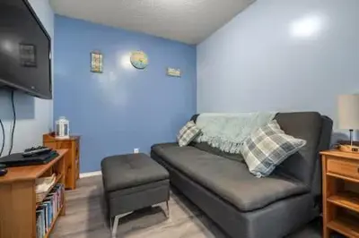 a living room with a couch and a chair at The Beach House Pool Access 5 Min Walk to Lake Sleeps 8 in Invermere