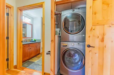 a kitchen with a washer and dryer in a house at Stunning 2bd hot tub walking distance to downtown in Canmore