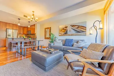 a living room with a couch and a table at Stunning 2bd hot tub walking distance to downtown in Canmore