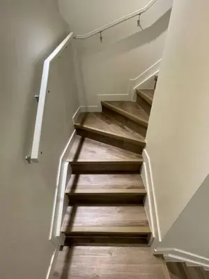 a staircase in a house with wooden floors at Bedroom in Southwest C in Edmonton