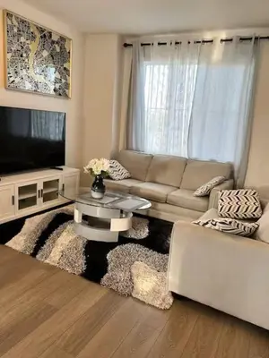 a living room with a couch and a tv at Bedroom in Southwest D in Edmonton