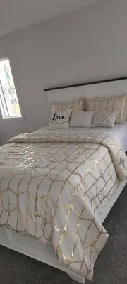 a bedroom with a white bed with lights on it at Bedroom with private bathroom in Southwest in Edmonton