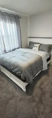 a bedroom with a large bed in a room at Bedroom with private bathroom in Southwest in Edmonton