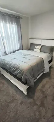 a bedroom with a large bed in a room at Bedroom with private bathroom in Southwest in Edmonton