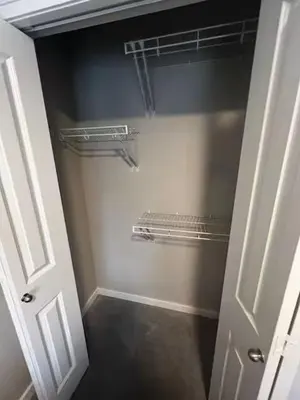 a walk in closet with a white door and shelves at Brand New Bedroom in Keswick B in Edmonton
