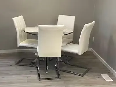three white chairs and a table in a room at Brand New Bedroom with private bathroom in Keswick in Edmonton